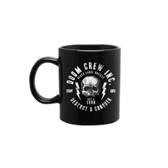 Black coffee mug featuring a skull design from Doom Crew Inc. for coffee lovers